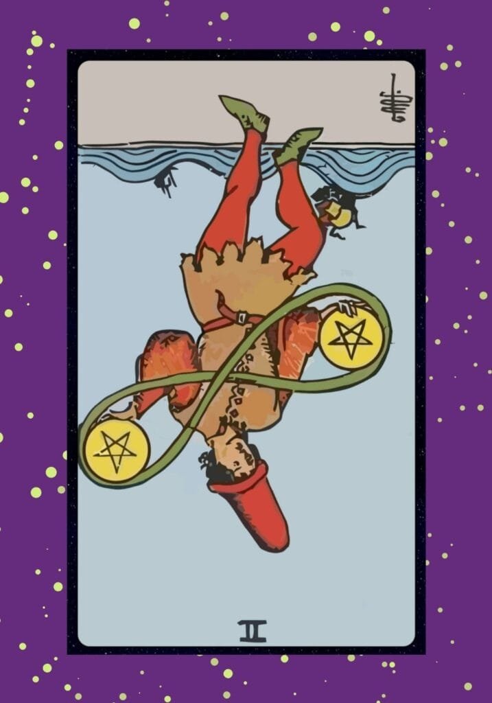 The Two of Pentacles appears reversed, with pentacles falling from the dancer’s grasp—signaling overwhelm, poor time management, or financial disarray.