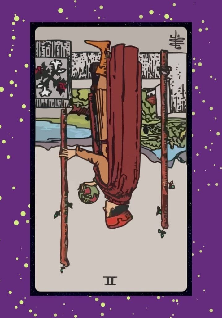 Reversed Two of Wands tarot card – indecision and fear of change, symbolizing missed opportunities, delayed travel, and reluctance to leave the comfort zone.