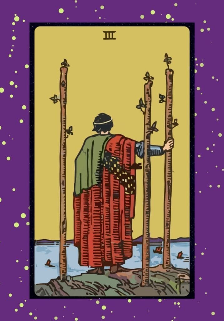 Upright Three of Wands tarot card – a man stands on a cliff gazing out over water with three wands planted beside him, symbolizing vision, expansion, and travel.